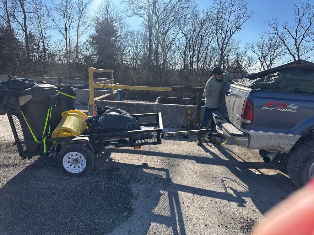 Missouri Junkers truck towing a trailer in a gravel lot